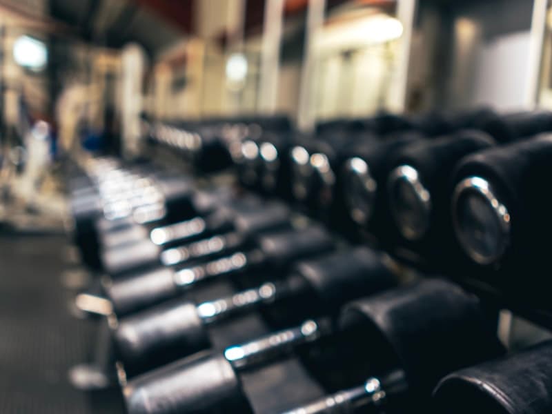 White-label mobile app mockup showing branded home screen, class schedule, and member profile